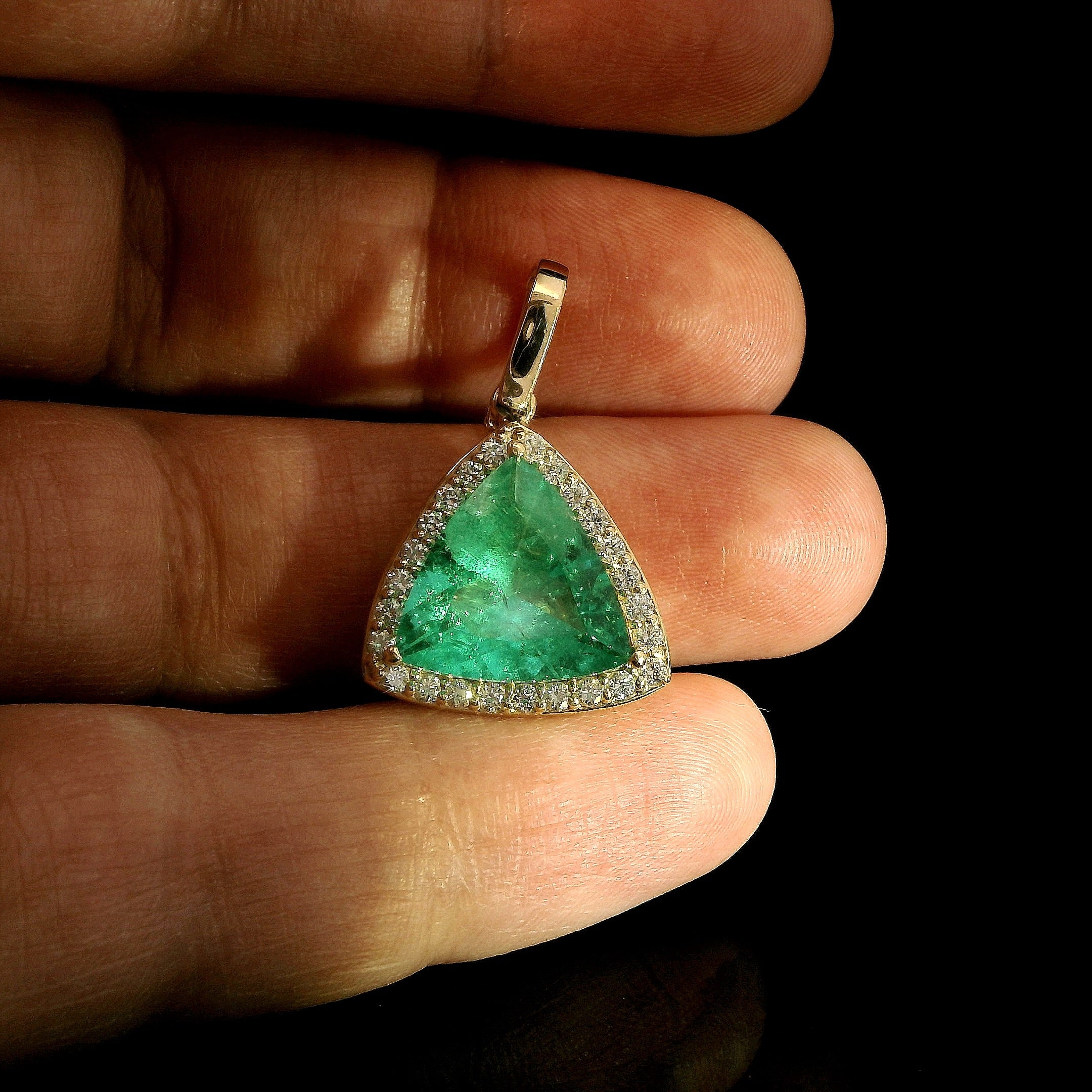 Trillion cut Colombian Emerald with diamond halo pendant