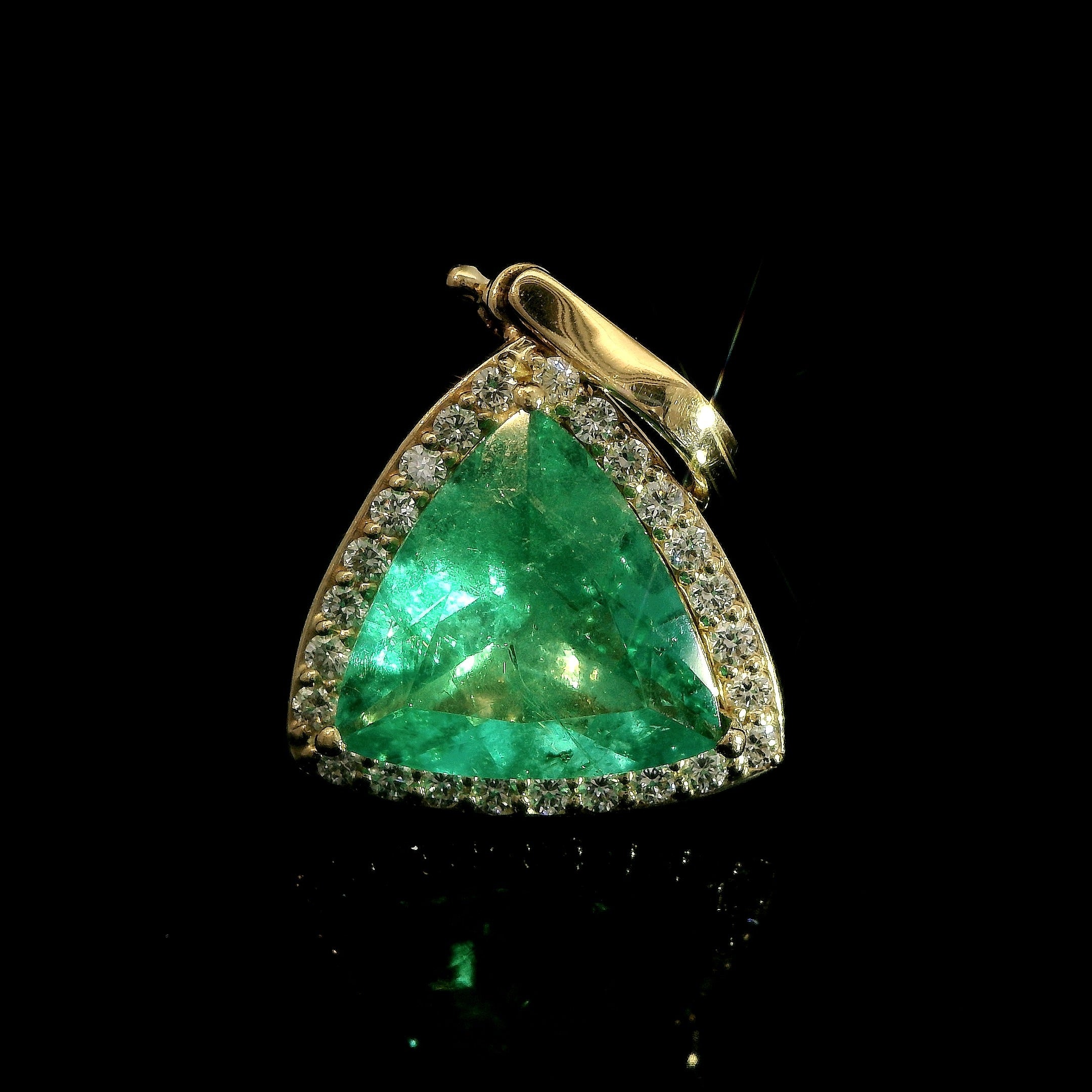 Trillion cut Colombian Emerald with diamond halo pendant