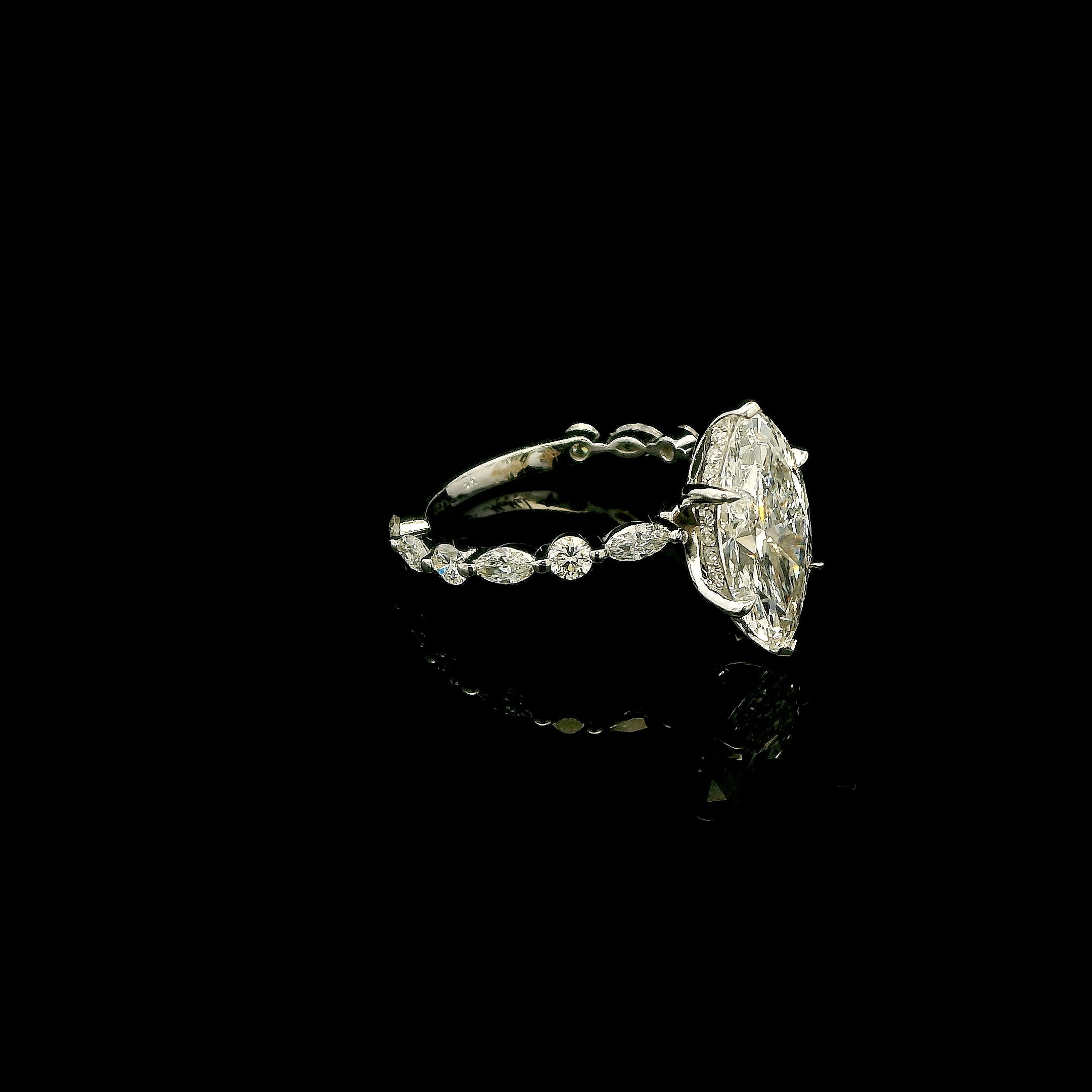 Marquise cut engagement ring with round and marquise diamond band